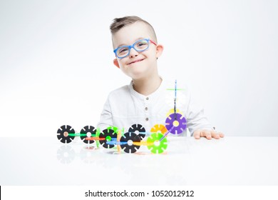 Happy Child With Down Syndrome Playing With Building Toys. 