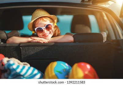 Happy Child Girl In Car Going On A Summer Vacation Trip
