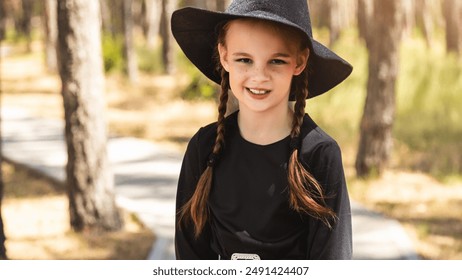 happy child girl in costumes of witch on outside in holiday Halloween - Powered by Shutterstock