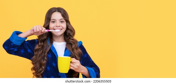 Happy Child Girl In Cozy Bathrobe Use Toothbrush And Cup, Personal Care. Banner Of Child Girl With Teeth Brush, Studio Portrait, Header With Copy Space.