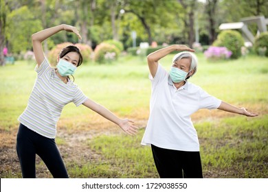 Happy Child Girl Is Doing Exercise Activity For The Old Elderly,healthy Senior Woman Workout And Wear Face Mask Outside Home After Coronavirus Quarantine Or Covid-19 Lockdown,work Out For Health Care