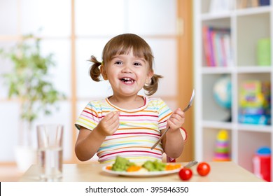 Happy Child Girl Eating Vegetables. Healthy Nutrition For Kids