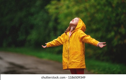 The Happy Child Girl Enjoying Autumn Rain
