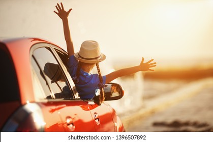 happy child girl goes to summer travel trip in the car - Shutterstock ID 1396507892