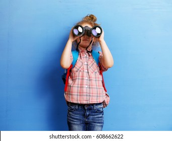 Happy Child Girl Playing With Binoculars. Explore And Adventure Concept