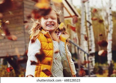 happy child girl playing little gardener in autumn and picking leaves into basket. Seasonal garden work. Backyard cleaning. - Powered by Shutterstock