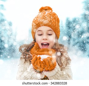 Happy child girl playing on a winter walk in nature