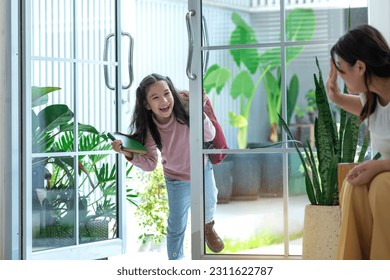 Happy child girl preparing for school, and saying bye to mom and walk out the door, Little girl with mother - Shutterstock ID 2311622787