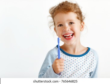 Happy Child Girl With Toothbrush Brushes Teeth And Smiles