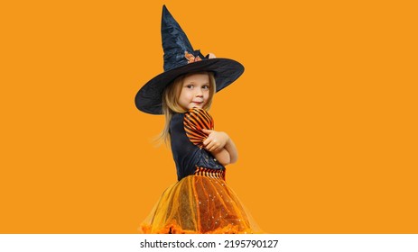 Happy Child Girl In Witch Costume. Halloween Party Time.