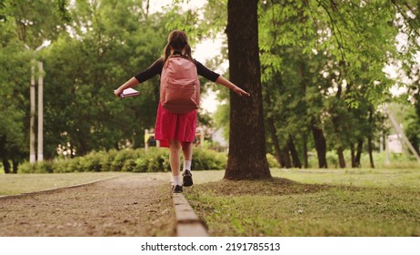 happy child goes school with backpack curb. kid with school bag textbook his hand park. Road school. view from back. happy childhood dream. childhood concept. schoolboy view from back. happy family - Powered by Shutterstock