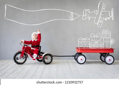 Happy Child Having Fun On Christmas Time. Kid Playing At Home. Xmas Holiday Concept