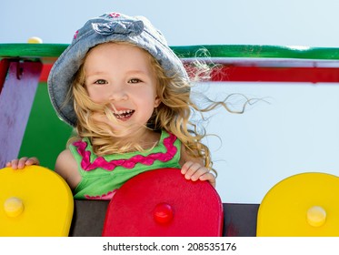 Happy Child Having Fun On The Playground