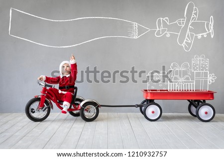 Happy child having fun on Christmas time. Kid playing at home. Xmas holiday concept