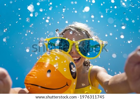 Happy child having fun on summer vacation. Outdoor portrait of kid against blue sky background. Spring break!