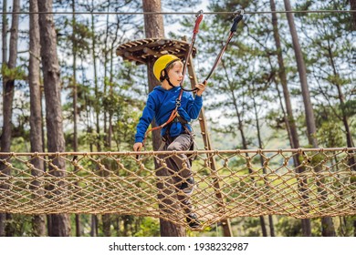 Happy Child In A Helmet, Healthy Teenager School Boy Enjoying Activity In A Climbing Adventure Park On A Summer Day