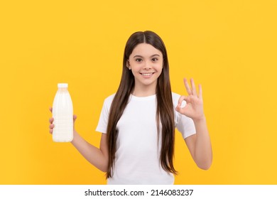 happy child hold dairy beverage product. teen girl going to drink milk. healthy lifestyle