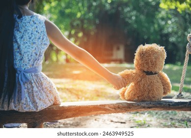 Happy Child hug teddy bear in green park playground. Teddy bear best friend for little kids cute girl. Autism happy funny playing together on playground in happiness family feel love and warm hugs - Powered by Shutterstock