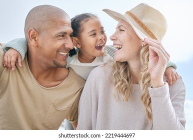 Happy, child and interracial parents at the beach for a holiday in summer in Indonesia together. Smile, playful and mother and father with care and affection for girl at the ocean on a vacation - Powered by Shutterstock