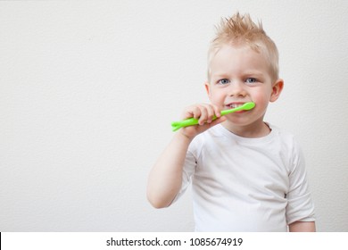 Happy child kid boy brushing teeth.Health care, dental hygiene, people and beauty concept. Mockup, free spase.