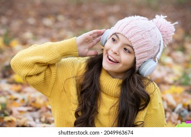 Happy Child Listen Music In Headphones Outdoor. Autumn Nature. September. Back To School.