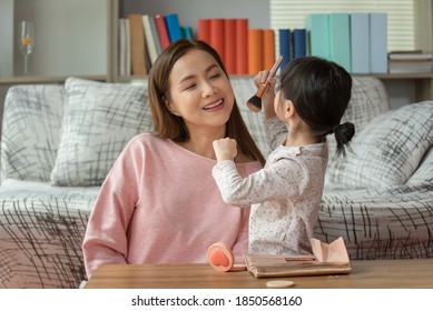 Happy Child, Little Asian Girl Doing Makeup With Her Mother, Loving Family Concept