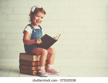 happy child little girl with a books - Shutterstock ID 373520338