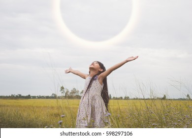 Happy Child Looking Up Arms Spread Wide To The Sunlight