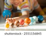 A happy child lying on the floor and plays with his toy planets. Selective focus. Children playing with toys concept.