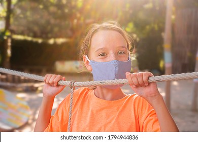 Happy Child In A Mask On The Playground