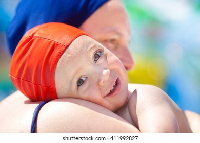 Happy Child And Mom With Swimming Pool Cap Have Fun In A Pool