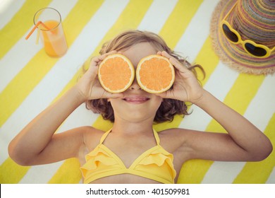 Happy Child On The Beach. Kid Having Fun Outdoors. Summer Vacation Concept. Top View Portrait