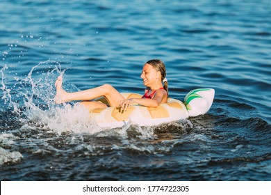 Happy child on an inflatable circle floating on the sea, Summer holidays with children. Swimming equipment and clothing for children.