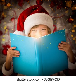 Happy Child Opening Magic Christmas Book. Xmas Holiday Concept