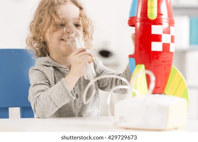 Happy Child With Oxygen Mask Playing With Toy Racket