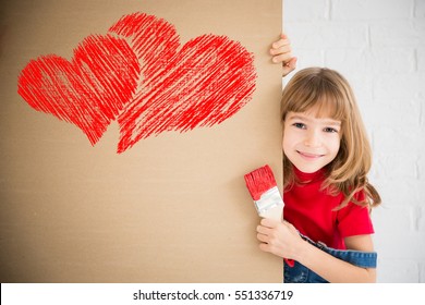 Happy Child Painting Big Red Heart On The Wall. Funny Girl Playing At Home. Valentines Day Card. Renovation And Design Concept