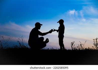 Happy Child With Parent Playing Baseball Concept In Park In Nature