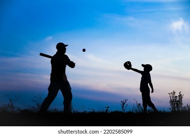 Happy Child With Parent Playing Baseball Concept In Park In Nature