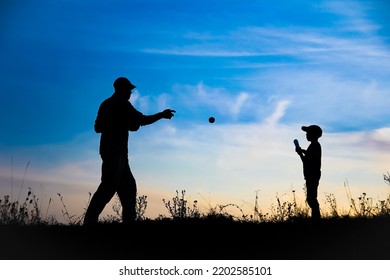 Happy Child With Parent Playing Baseball Concept In Park In Nature