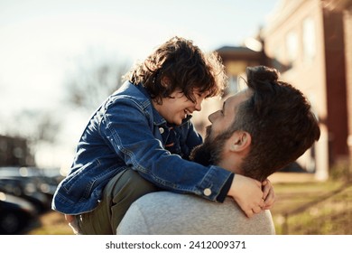 Happy child playing with father in sunny suburban street - Powered by Shutterstock