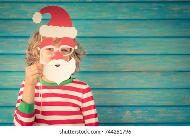 Happy Child Playing At Home. Funny Kid On Christmas Eve. Xmas Winter Holiday Concept