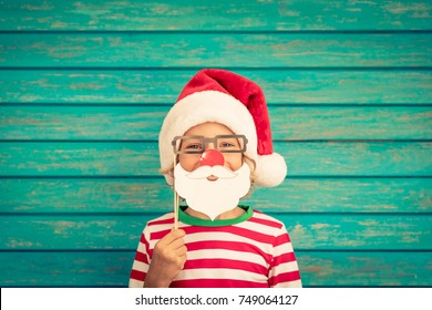 Happy Child Playing At Home. Funny Kid On Christmas Eve. Xmas Winter Holiday Concept