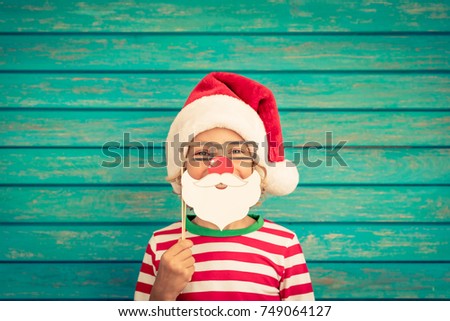 Happy child playing at home. Funny kid on Christmas eve. Xmas winter holiday concept