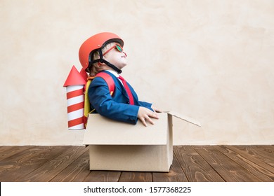 Happy child playing at home. Rocket boy having fun. Success, creative and imagination concept
