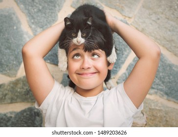 Happy Child Playing With Kitten Outdoor