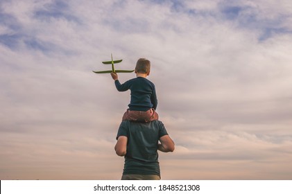 Happy child playing outdoors. Boy play airplane.  Little kid dreams of being a pilot. - Powered by Shutterstock