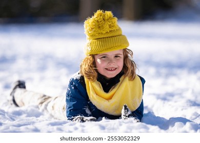 Happy Child playing with snow during snowfall. Snowball fight Child in winter clothes throw snowball. Winter children play with snow. Kid play with snowball. Winter kids face. Boy play snowball.