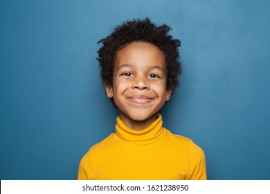 Happy Child Portrait. Little African American Kid Boy On Blue Background