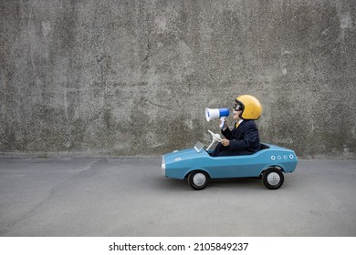 Happy Child Pretend To Be Businessman. Funny Kid Driving Retro Pedal Car Outdoor. Back To Work, Start Up And Business Idea Concept