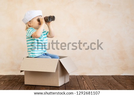 Happy child pretend to be sailor. Funny kid playing at home. Summer vacation and travel concept